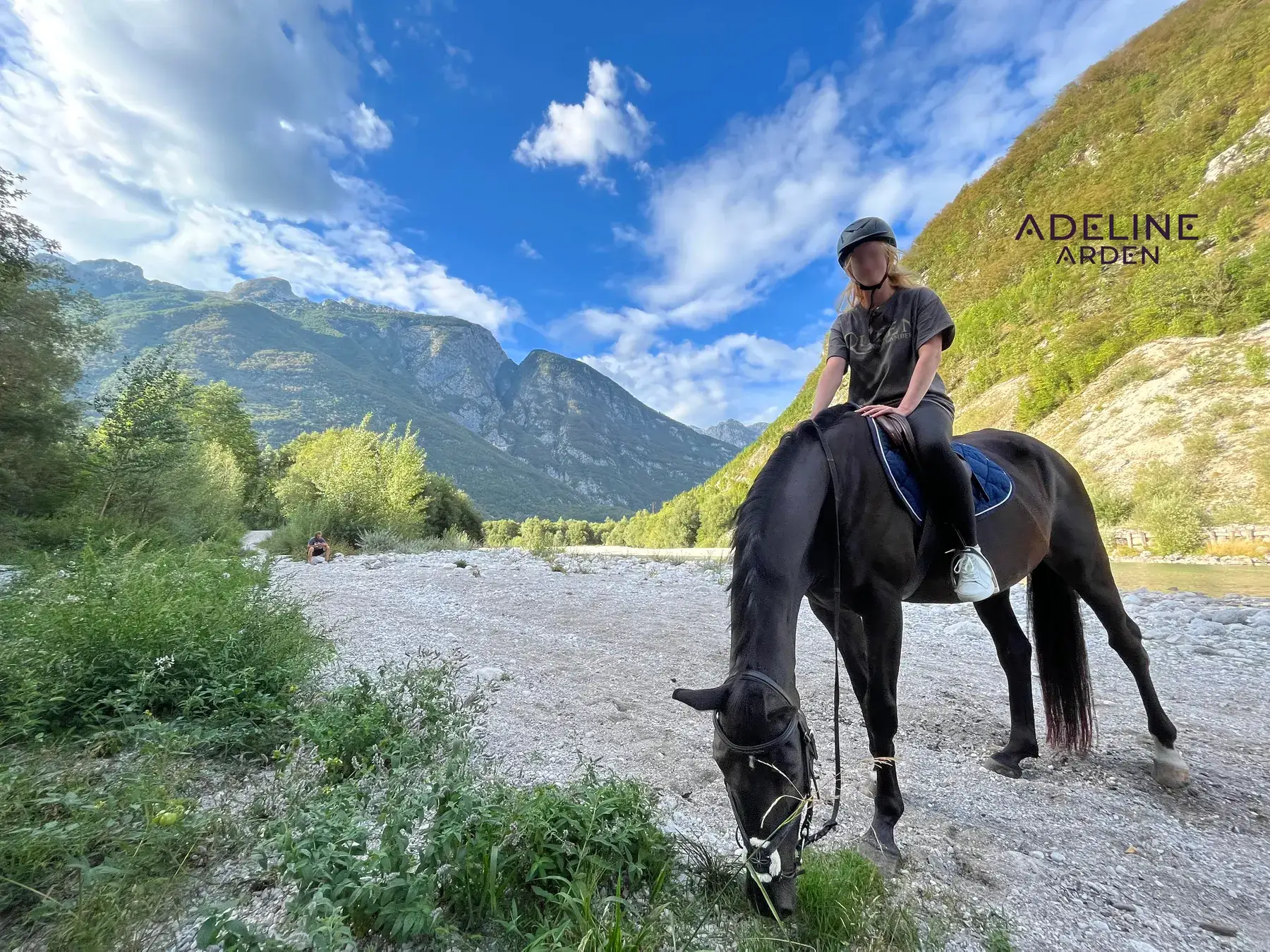 Adeline on horseback in a mountain valley